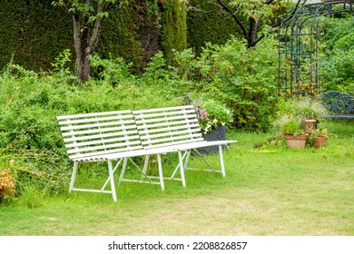 A White Bench In An English Garden.