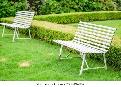 A White Bench In An English Garden.