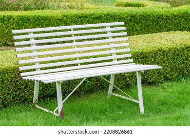 A White Bench In An English Garden.