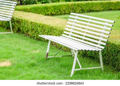 A White Bench In An English Garden.