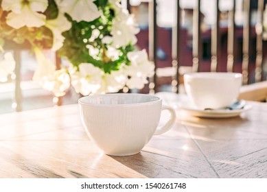 White big cup of delicious coffee on wooden table in sunset light with copy space. Lifestyle view. - Shutterstock ID 1540261748