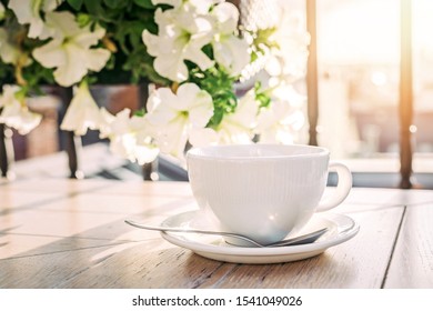 White big cup of delicious coffee on wooden table in sunset light with copy space. Lifestyle view. - Shutterstock ID 1541049026