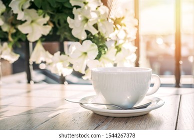 White big cup of delicious coffee on wooden table in sunset light with copy space. Lifestyle view. - Shutterstock ID 1544267378