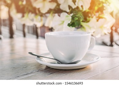 White big cup of delicious coffee on wooden table in sunset light with copy space. Lifestyle view. - Shutterstock ID 1546136693