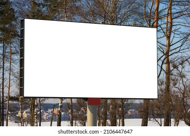 White Billboard Along The Highway On A Winter Snow Day. Background For Design And Advertising. 