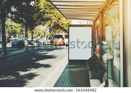 White billboard on empty bus stop with copy space zone for your logo or message, public information board near highway, city bus stop with blank mock-up banner for advertising or promotion