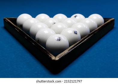 White billiard balls for billiards, a triangle on the table. White billiard balls for billiards on a blue background