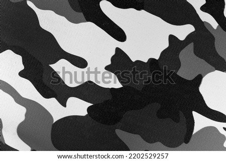 White black camouflage pattern fabric background texture. military and hunting clothes. winter and snow camouflage