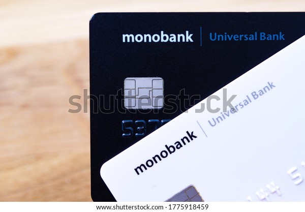 White and black card Monobank. Plastic debit\
black and white card on a wooden background. Monobank. July, 2020.\
Kiev, Ukraine