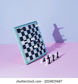 White And Black Chess Board And Pieces Defy Gravity On Pink And Grey Background. Minimal Concept.