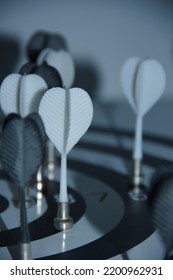 White And Black Darts On A Metal Target