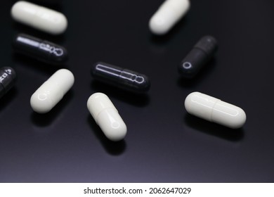 White And Black Drug Gel Capsules Abstract