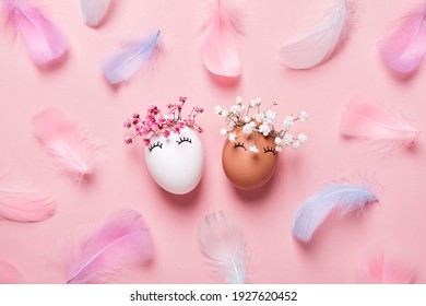 White And Black Easter Eggs With Natural Flowers Wreath On Soft Pink Feathers Background. Zero Waste Easter Concept. Racial Equality Symbol