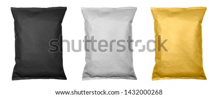 White, black and gold pillow bag of chips , snacks or candys top view. Isolated on a white background.