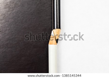 White and black pencils. Contrast and opposite concept