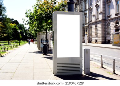 White Blank Advertising And Commercial Panel. Mockup Base. Poster Or Banner Background. Soft Urban Green Background. Vertical Format Ad Panel. Stucco Elevation. Concrete Sidewalk. Old European Scene