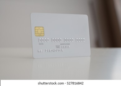 White Blank Bank Credit Card On Soft Blurred Background