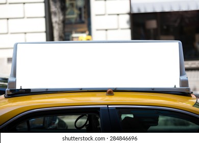 White blank billboard on the taxi roof. Yellow cab in New York City.