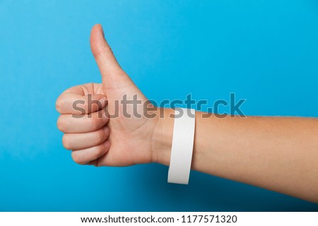 White blank bracelet on hand. Music festival branding wristband, adhesive paper accessory for concert, event. mockup.