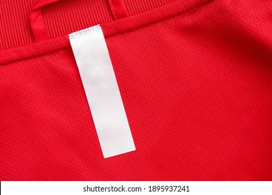 White Blank Clothes Label On Red Jersey Texture Background