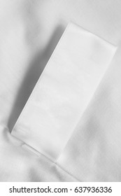 White Blank Clothes Label On White Cloth As A Background