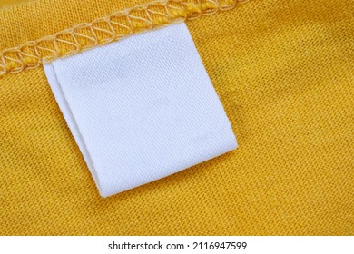 White Blank Clothing Tag Label On New Yellow Shirt Background