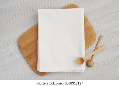 White Blank Cotton Kitchen Towel Mockup For Design Presentation, Wooden Spoons And Cutting Board.