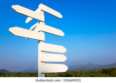 White blank directional sign in the mountain background