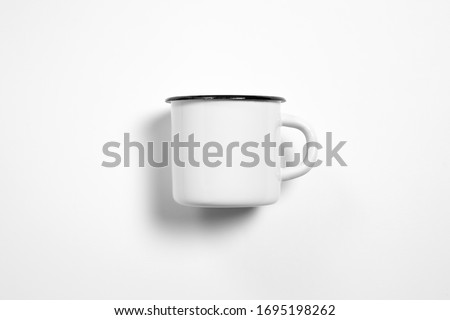 White blank Enamel Mug Mock-up isolated on white background. Blank cup for branding. High-resolution photo.