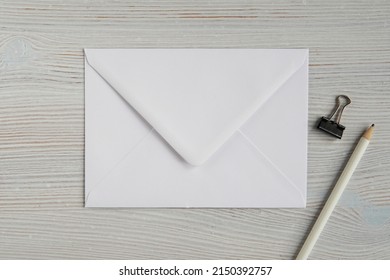 White Blank Envelope Mockup For Design Or Address Label Presentation, Flat Lay Composition With White Pencil.	
