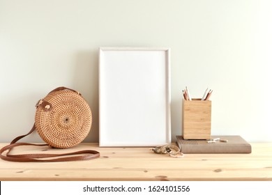 White Blank Frame Mockup For Poster Or Photo On Wooden Shelf, Round Rattan Bag, Boho Style Bracelets.
