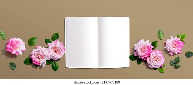 White Blank Notebook With Pink Roses Overhead View - Flat Lay
