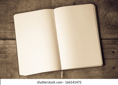 White blank pages sketch book on wood table vertical  