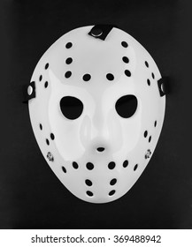 White Blank Plastic Hockey Mask On Reflective Surface.