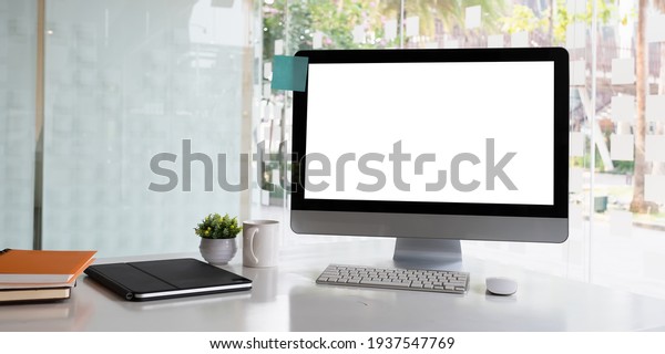 White blank\
screen monitor on modern working\
desk