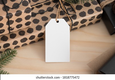 White Blank Tag Mockup Isolated On A Kraft Christmas Gift.