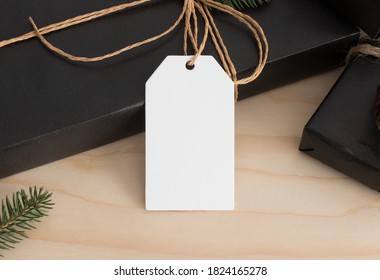 White Blank Tag Mockup Isolated On A Black Christmas Gift.