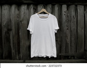 White Blank T-shirt On Dark Wood Wall