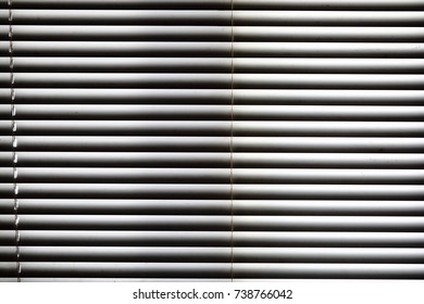 white blind shade curtain and shadow