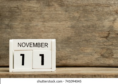 White block calendar present date 11 and month November on wood background