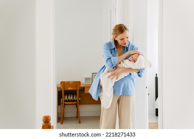 White Blonde Woman Wearing Shirt Holding Her Baby While Resting At Home