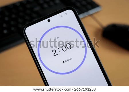 White and blue 2-minute timer with blue circle on phone screen to study or be productive. Student time planning studying, homework, office productivity.