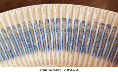 White And Blue Ceramics Ribbed Texture Closeup. Edge Of Glaze Pottery Dish. Abstract Textured Background. Kitchen Utensil Details. 