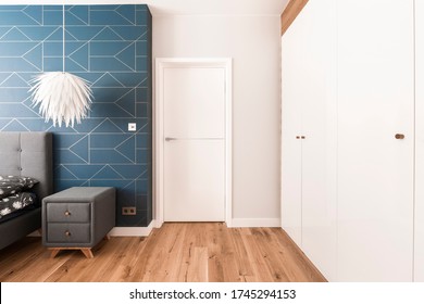 White, Blue And Grey Design Of Stylish Bedroom Interior With Closed Door