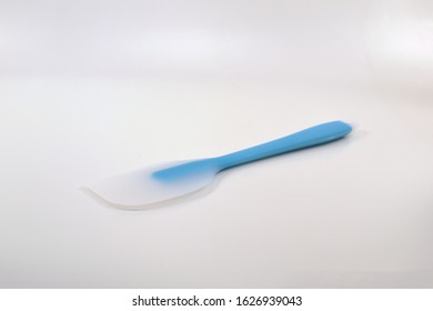 White And Blue Rubber Spatula On White Background.