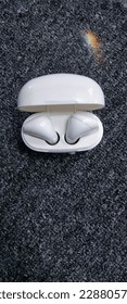 white bluetooth headset, black background 
