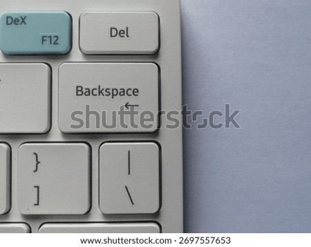 White bluetooth keyboard focus on backspace on white background