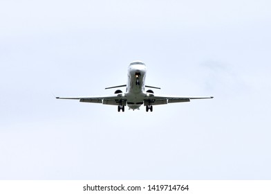 White Bombardier CRJ-900 is landing. The turbo-ventilator plane is white, clear. Photo from the bottom of the plane. The plane is landing at Rzeszow-Jasionka Airport.