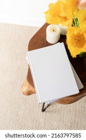 White Book Blank Cover Mockup On Stylish Wooden Coffee Table With Tulips Bouquet, High Angle View. Mock Up Design