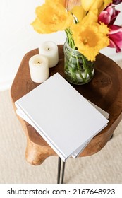 White Book Blank Cover Mockup On Stylish Wooden Coffee Table With Tulips Bouquet, High Angle View